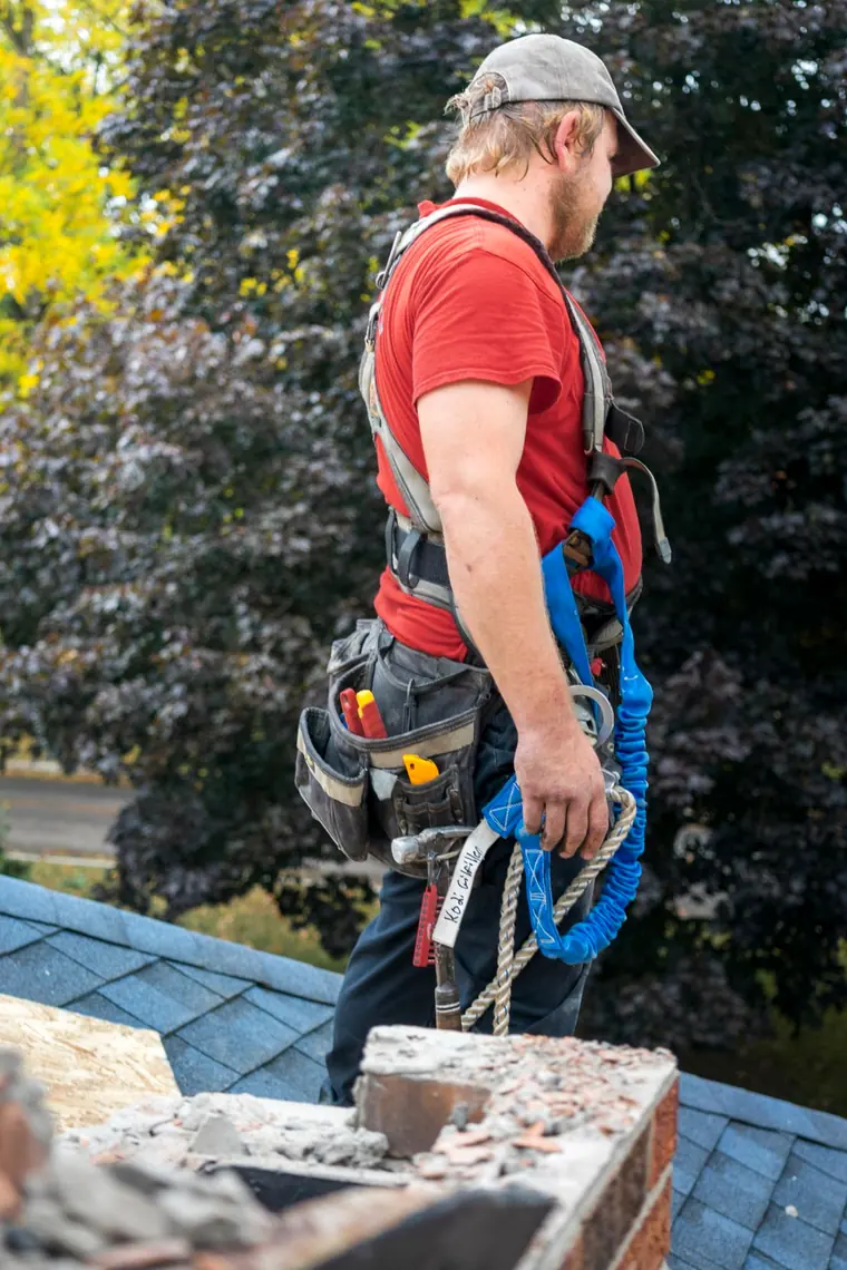 Chimney technician working on a rooftop chimney in Edison, New Jersey